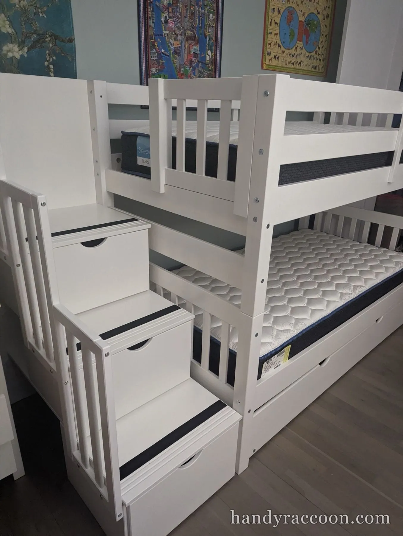Close view of a white bunk bed staircase with pull-out storage drawers built into the steps.