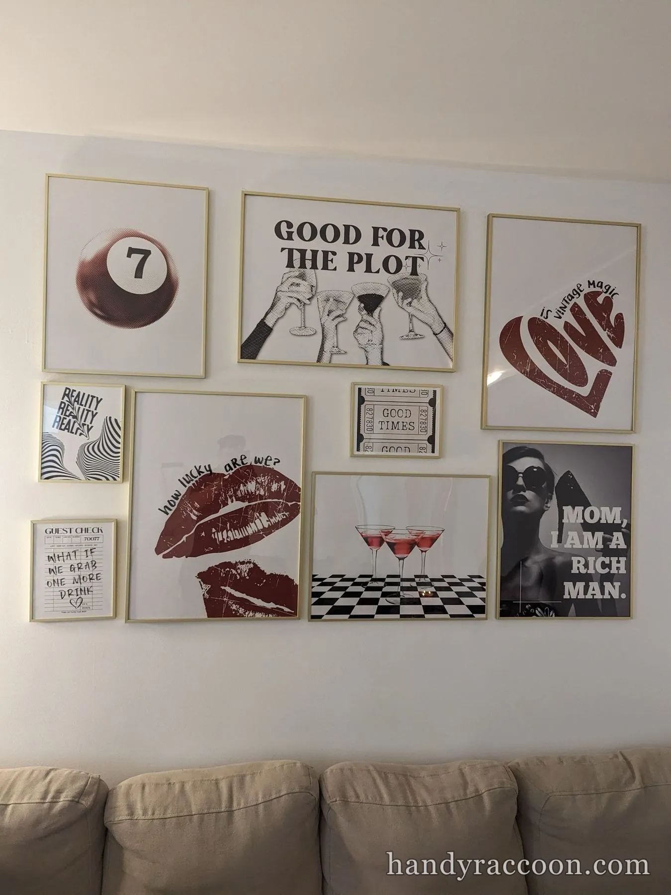 Gallery wall of red and black graphic posters arranged in a grid above a beige sofa.