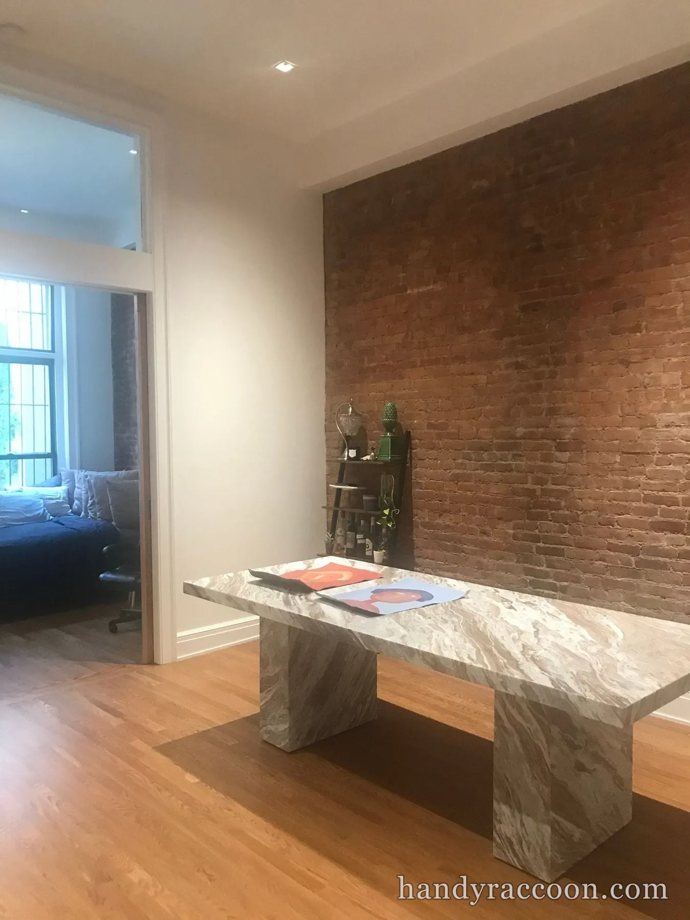 Empty room with greige painted walls, dark baseboards, ceiling fan, and hardwood floor.
